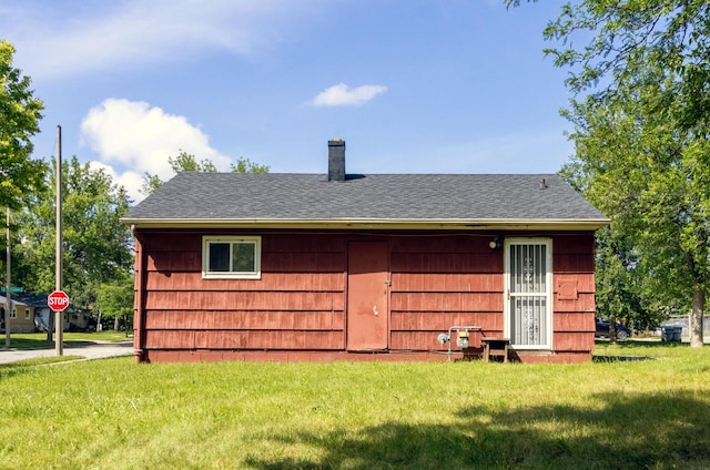 rear view of house with a lawn