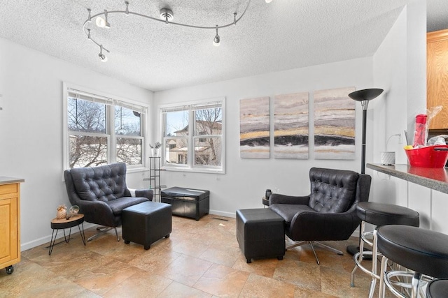 living area featuring a textured ceiling