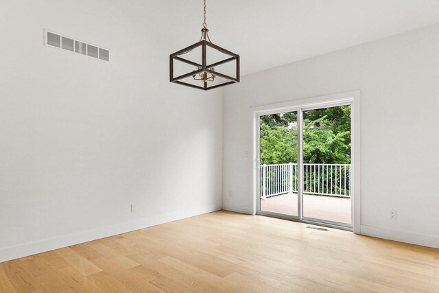 interior space featuring light wood-type flooring and a notable chandelier