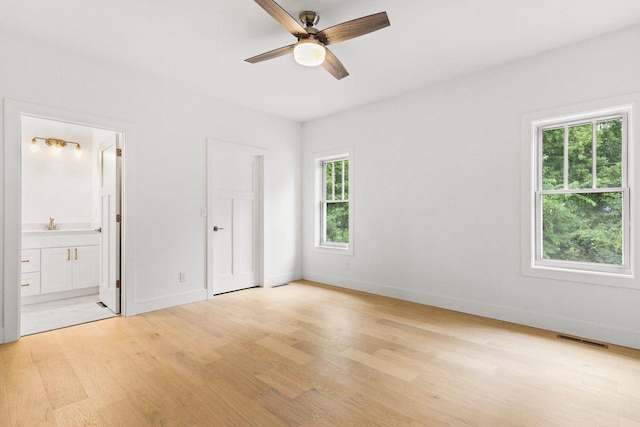 unfurnished bedroom with light hardwood / wood-style floors, ensuite bath, and ceiling fan