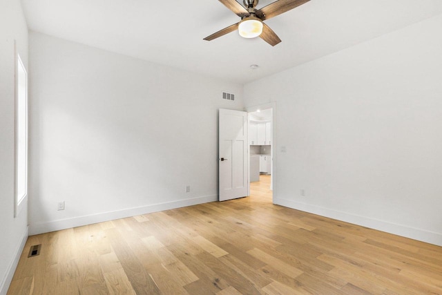 spare room featuring light wood-type flooring and ceiling fan