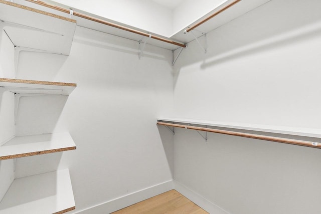 spacious closet featuring hardwood / wood-style floors