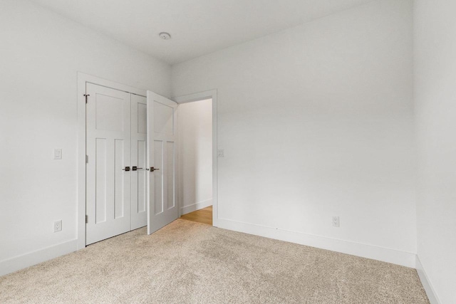 spare room with light colored carpet