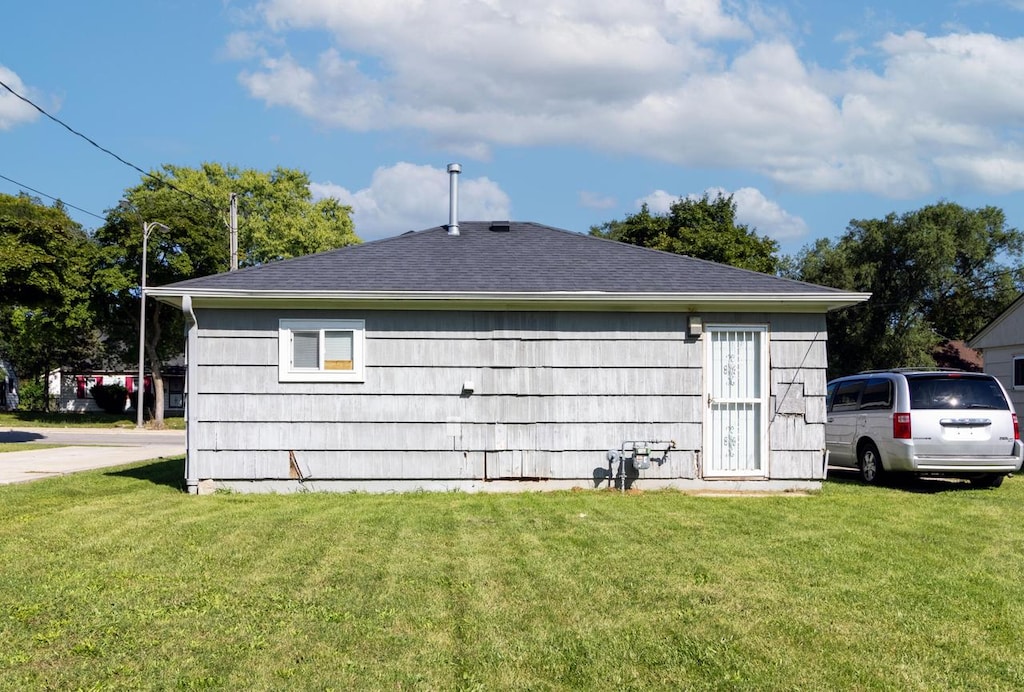 view of side of home with a lawn