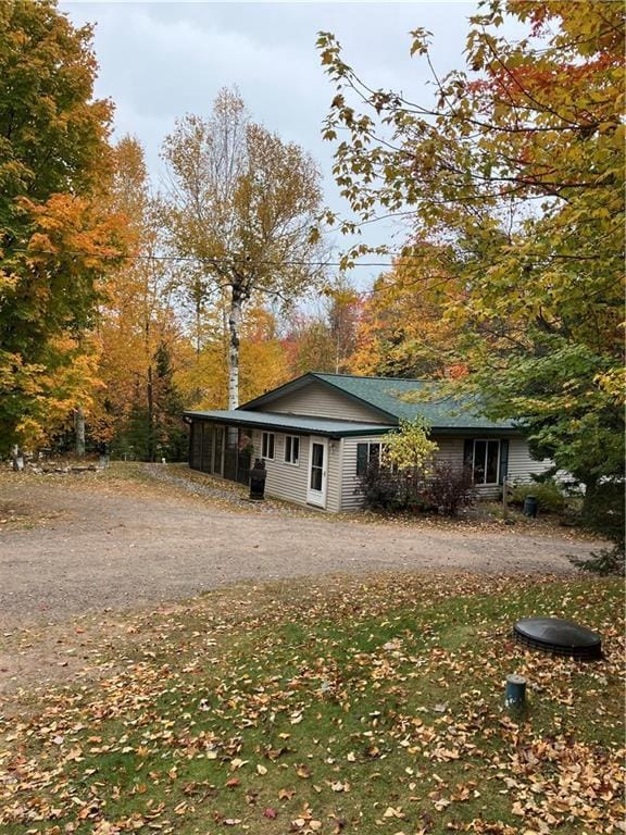 view of side of home featuring a sunroom