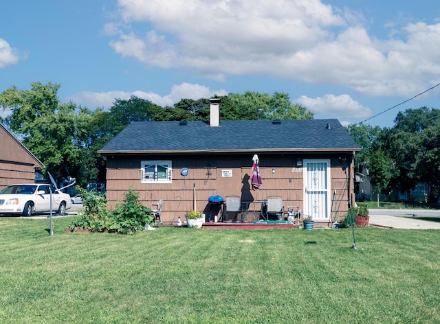 back of property featuring a lawn