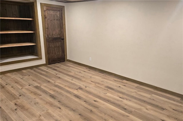 empty room with light hardwood / wood-style flooring