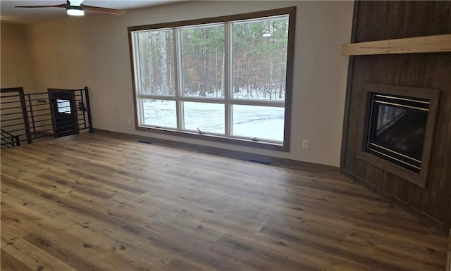 living room with ceiling fan, dark hardwood / wood-style flooring, and a fireplace