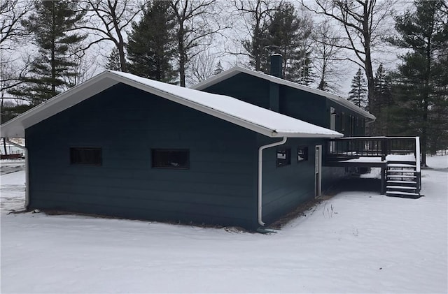 view of snow covered exterior featuring a deck