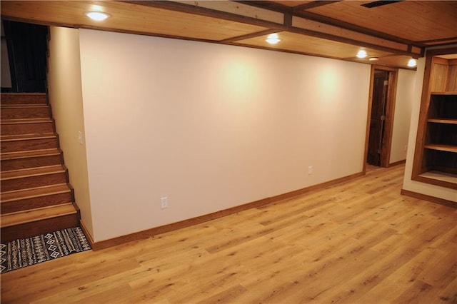 basement with light hardwood / wood-style floors and wood ceiling