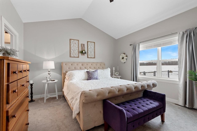 carpeted bedroom featuring lofted ceiling