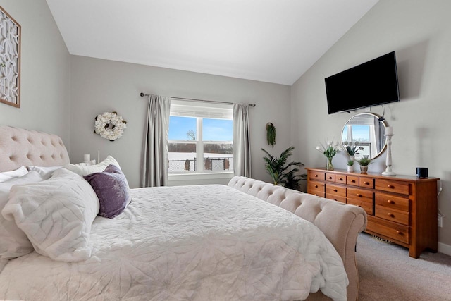 carpeted bedroom with lofted ceiling