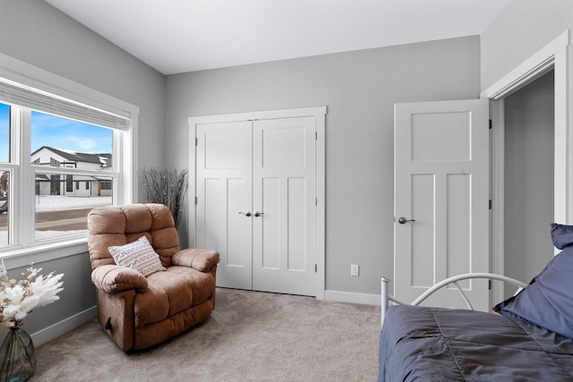 bedroom with light colored carpet and a closet