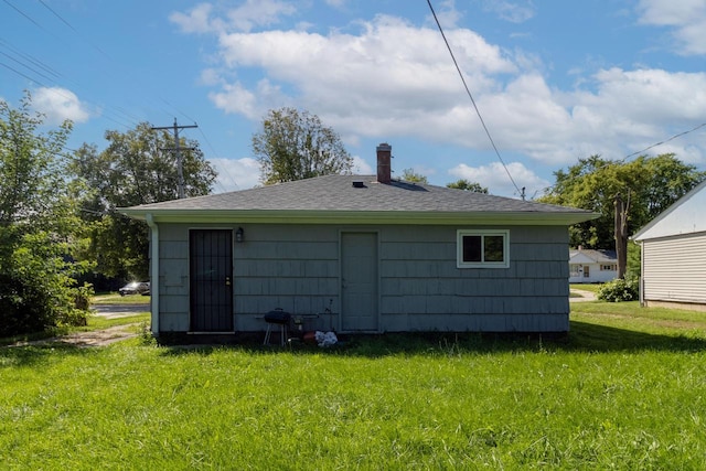 rear view of property with a lawn