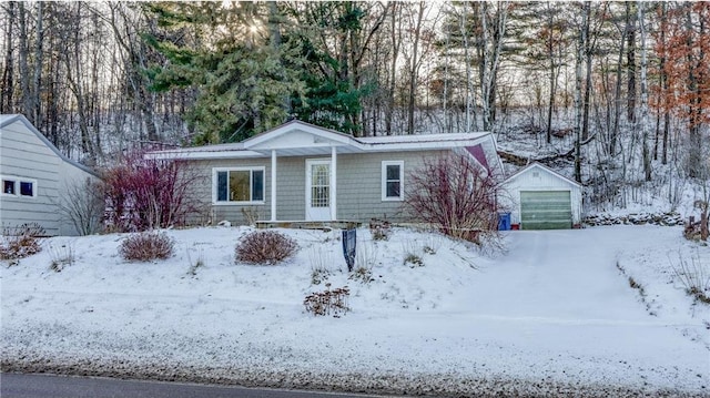 ranch-style home with a garage and an outbuilding