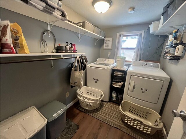 washroom featuring dark wood-type flooring and washing machine and clothes dryer