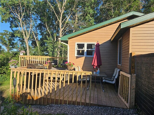 wooden deck with a grill