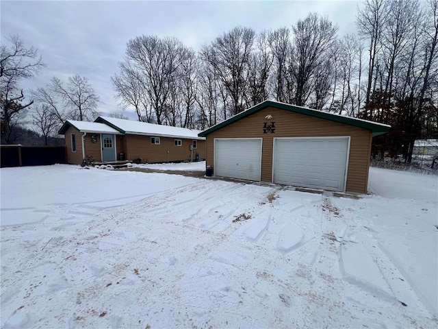 view of front of house featuring a garage and an outdoor structure