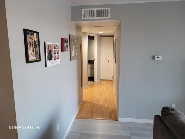 hall with light hardwood / wood-style flooring