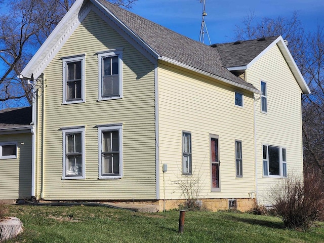 rear view of house with a yard