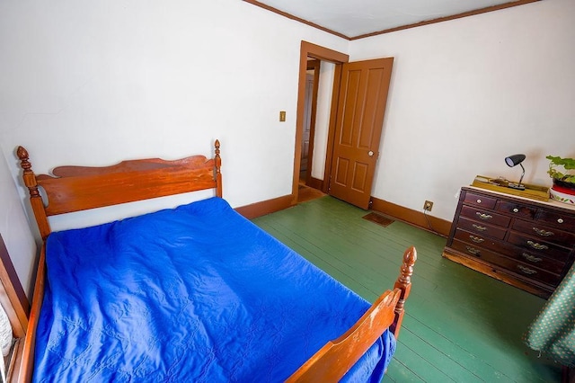 bedroom featuring dark hardwood / wood-style flooring and ornamental molding