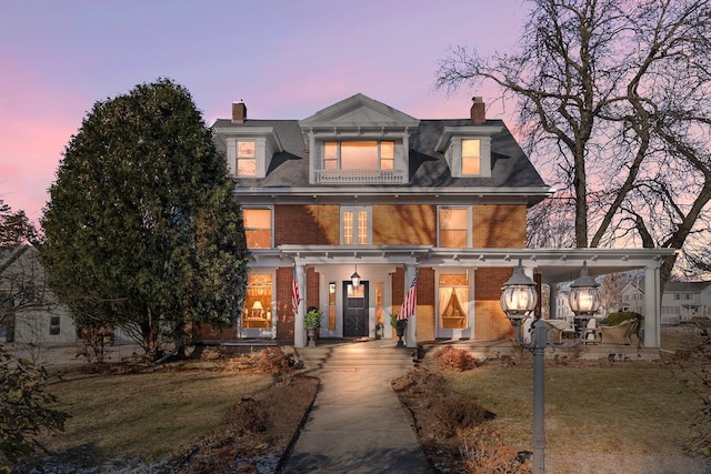 view of front of home featuring a lawn and covered porch