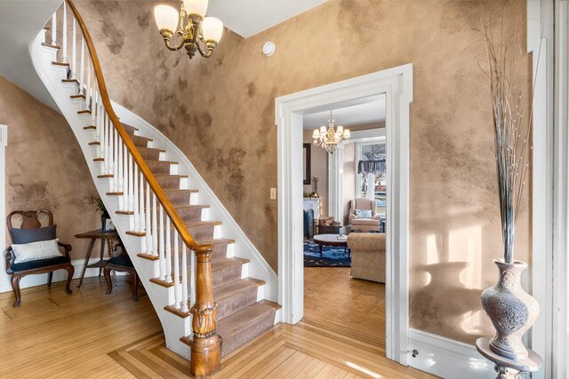 staircase featuring a chandelier