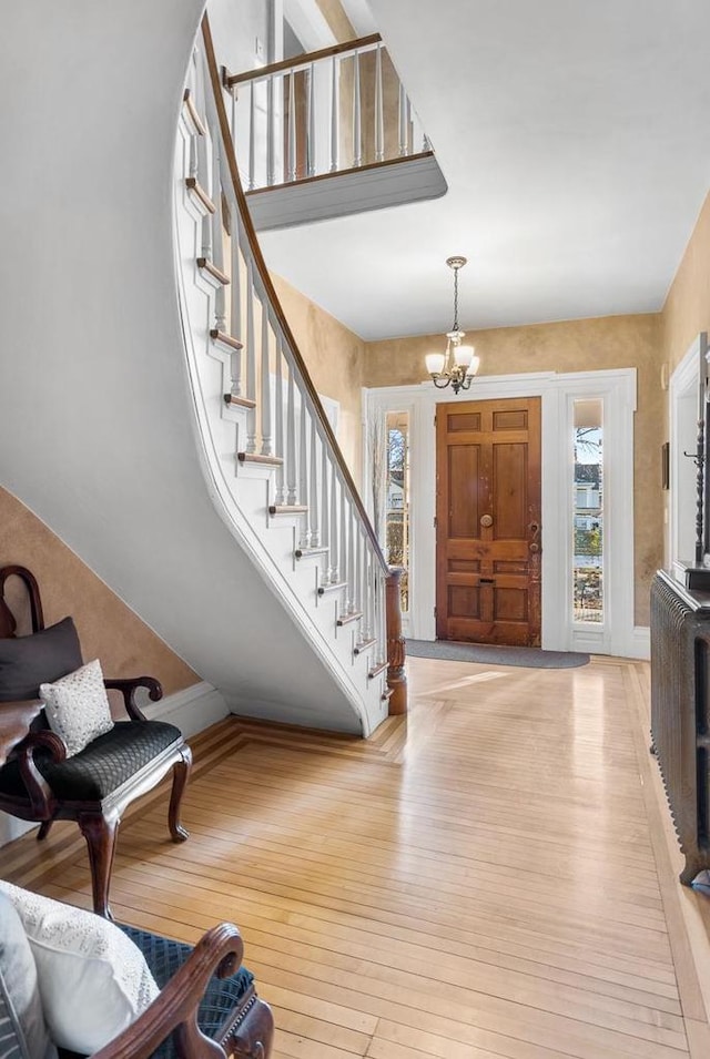 entrance foyer featuring light hardwood / wood-style floors and an inviting chandelier