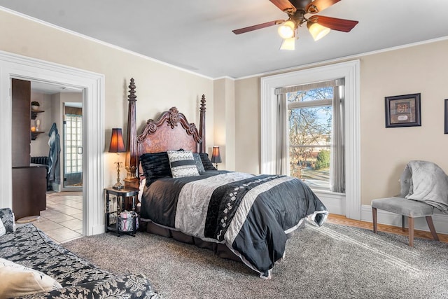 carpeted bedroom with ceiling fan and crown molding