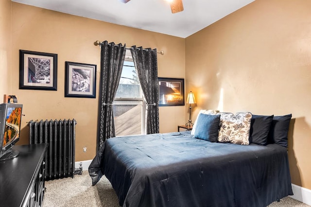 carpeted bedroom featuring ceiling fan and radiator heating unit