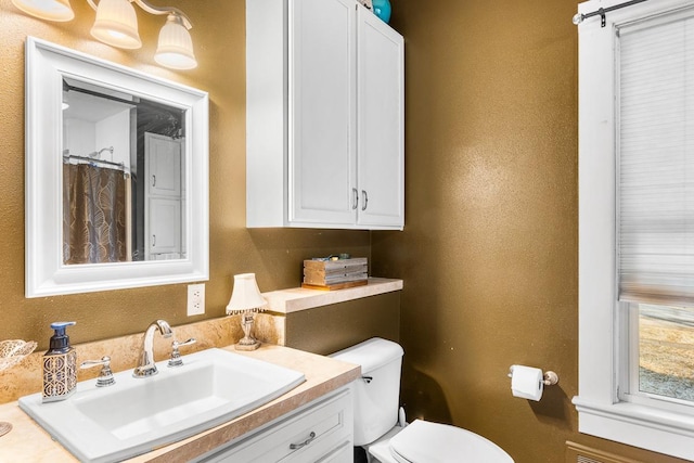 bathroom featuring vanity and toilet