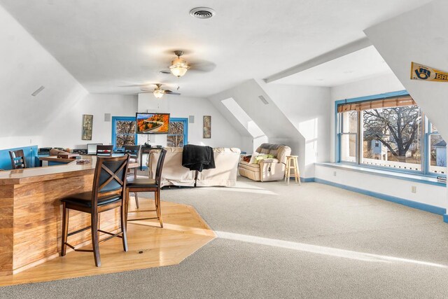 carpeted home office with ceiling fan and lofted ceiling