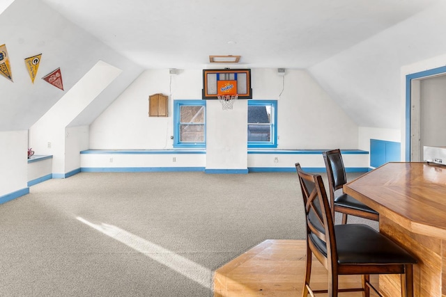additional living space featuring carpet and vaulted ceiling