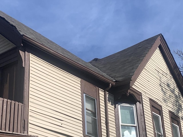 view of side of property with a shingled roof