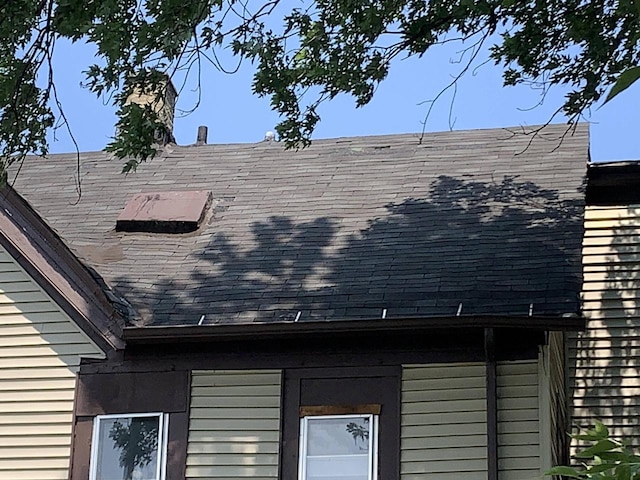 exterior details featuring a shingled roof