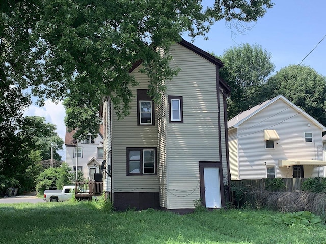 rear view of house with a lawn