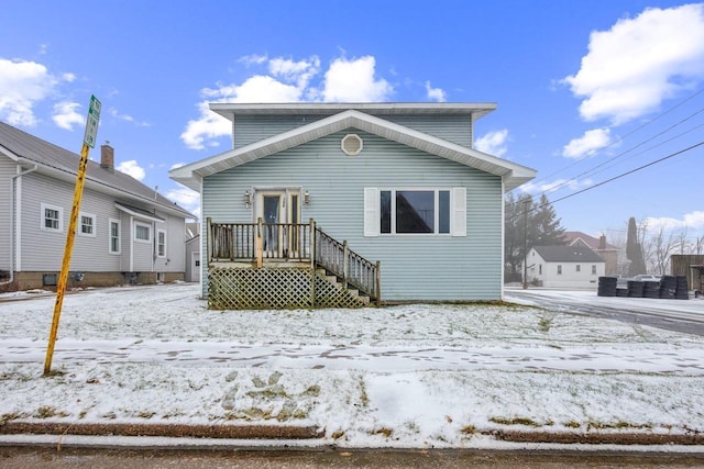 view of snow covered rear of property