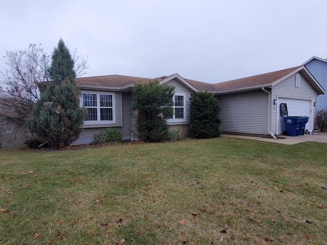 view of front of home with a garage and a front lawn