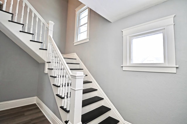 staircase with hardwood / wood-style floors and plenty of natural light