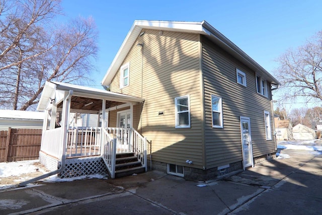 back of house featuring a porch