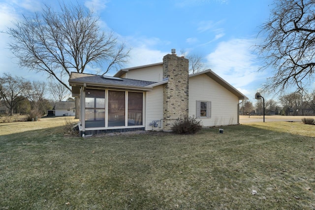 back of house featuring a sunroom and a yard