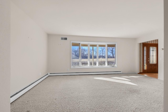 empty room with carpet flooring and baseboard heating