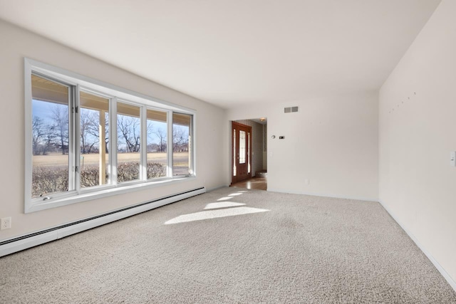 unfurnished room featuring carpet and a baseboard heating unit