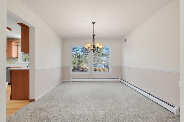 carpeted dining space with sink, a baseboard heating unit, and an inviting chandelier