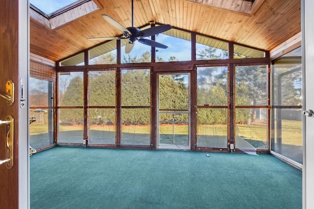 unfurnished sunroom featuring a wealth of natural light, ceiling fan, and wood ceiling