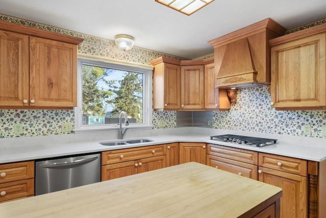 kitchen with dishwasher, sink, wood counters, white gas cooktop, and custom range hood