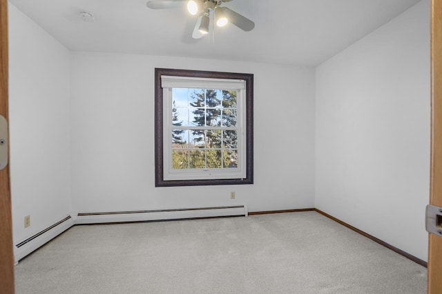 carpeted spare room featuring baseboard heating and ceiling fan