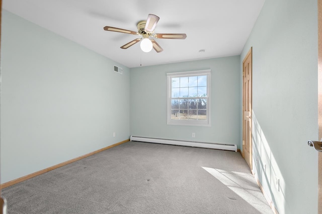 carpeted spare room featuring baseboard heating and ceiling fan