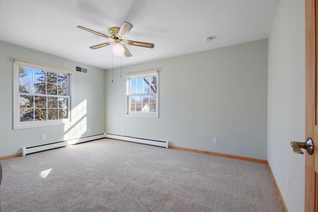 carpeted spare room featuring ceiling fan and a baseboard heating unit