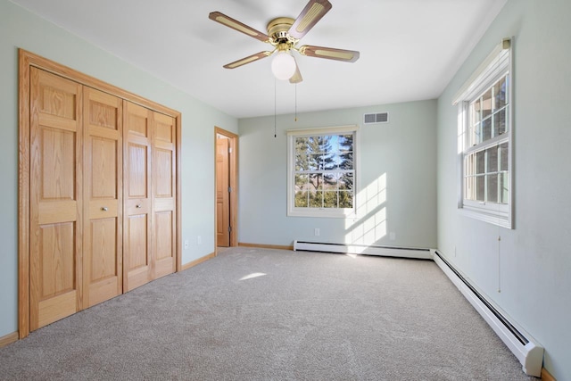 unfurnished bedroom with ceiling fan, a closet, carpet floors, and a baseboard radiator